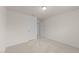 A bright bedroom featuring neutral carpet, light walls and an open doorway at 3413 Dragonfly River Ct, Raleigh, NC 27604