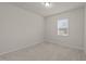Clean, carpeted bedroom with a single window and neutral paint, ready for personalization at 3413 Dragonfly River Ct, Raleigh, NC 27604