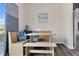 A cozy breakfast nook with wooden bench seating, decorative pillows, and a table, adjacent to the kitchen at 3413 Dragonfly River Ct, Raleigh, NC 27604