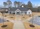 Community clubhouse featuring a pool, covered outdoor seating, and beautiful landscaping at 3413 Dragonfly River Ct, Raleigh, NC 27604