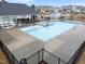 Community pool featuring a diving platform, picnic tables, outdoor grilling stations, and bath house at 3413 Dragonfly River Ct, Raleigh, NC 27604