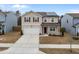 Charming two-story home with a two-car garage and solar panels against a blue sky at 3413 Dragonfly River Ct, Raleigh, NC 27604