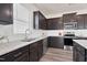 Bright kitchen with granite countertops, stainless steel appliances, and wood-look floors at 3413 Dragonfly River Ct, Raleigh, NC 27604