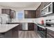 Stylish kitchen with granite countertops, stainless steel appliances, and dark wood cabinets at 3413 Dragonfly River Ct, Raleigh, NC 27604