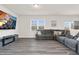 Bright and airy living room with a comfortable gray sectional sofa, entertainment center, and scenic views at 3413 Dragonfly River Ct, Raleigh, NC 27604