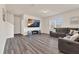 Spacious living room with gray sectional sofa, media center, and large windows for natural light at 3413 Dragonfly River Ct, Raleigh, NC 27604