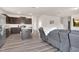 Open-concept living space with a modern kitchen, comfortable seating, and natural light at 3413 Dragonfly River Ct, Raleigh, NC 27604