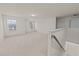 Spacious loft with large windows providing plenty of natural light and soft carpeting at 3413 Dragonfly River Ct, Raleigh, NC 27604