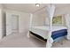 Spacious main bedroom with four poster bed, neutral carpet and decor at 3413 Dragonfly River Ct, Raleigh, NC 27604