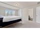 Bright main bedroom showcasing a four-poster bed and ensuite access at 3413 Dragonfly River Ct, Raleigh, NC 27604