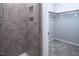 Walk-in shower with tiled walls and built-in shelving next to closet with shelves and clothes bar at 345 Rubrum Dr, Hillsborough, NC 27278