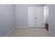Spacious bedroom with neutral carpeting, light-colored walls, and double doors, creating a calming and inviting atmosphere at 345 Rubrum Dr, Hillsborough, NC 27278