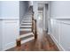 Inviting foyer with hardwood floors, wainscoting, and an elegant staircase at 345 Rubrum Dr, Hillsborough, NC 27278