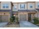 Charming townhome featuring stone accents, gray siding, and a well-manicured front yard at 345 Rubrum Dr, Hillsborough, NC 27278