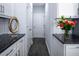 Hallway with dark wood floors, white cabinets, and granite countertop at 345 Rubrum Dr, Hillsborough, NC 27278
