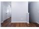 Hallway with hardwood floors, leading to storage, and a staircase at 345 Rubrum Dr, Hillsborough, NC 27278