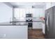 Bright kitchen with white cabinets, granite counters, and a stainless steel refrigerator at 345 Rubrum Dr, Hillsborough, NC 27278