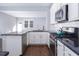 Well-lit kitchen featuring white cabinets, stainless appliances, and granite countertops at 345 Rubrum Dr, Hillsborough, NC 27278