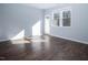 Bright living room with rich hardwood floors, neutral paint, and lots of natural light at 345 Rubrum Dr, Hillsborough, NC 27278