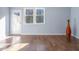 Bright room with hardwood floors, natural light, and a door to the backyard at 345 Rubrum Dr, Hillsborough, NC 27278