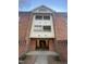 Close-up of the brick apartment entrance with two-story portico and unit numbers at 3520 Ivy Commons Dr # 302, Raleigh, NC 27606