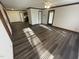 Open-concept living space with updated flooring connecting living, dining, and kitchen areas at 3520 Ivy Commons Dr # 302, Raleigh, NC 27606