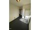 A room featuring smooth floors, bright walls, a closet for storage, and access to the outdoors at 3520 Ivy Commons Dr # 302, Raleigh, NC 27606