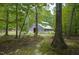 Rustic barn on a property with a path leading up to it, surrounded by trees and greenery at 3560 Nc 98, Youngsville, NC 27596