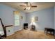 Cozy blue bedroom with carpet, ceiling fan, window and traditional furniture providing a calm, inviting atmosphere at 3560 Nc 98, Youngsville, NC 27596
