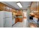Kitchen with oak cabinets, tile floors, granite countertops and white appliances at 3560 Nc 98, Youngsville, NC 27596