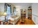 Bright living room with hardwood floors, large windows with decorative drapes, and classic trim and a glass cabinet at 3560 Nc 98, Youngsville, NC 27596