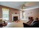 Comfortable living room with a fireplace, ceiling fan and a leather couch at 3560 Nc 98, Youngsville, NC 27596