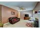 Cozy living room featuring a fireplace, ceiling fan and comfortable seating at 3560 Nc 98, Youngsville, NC 27596