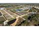 Aerial shot of a commercial Bedroom with rows of plants, greenhouses and water features at 3916 Bostwyck Dr, Fuquay Varina, NC 27526