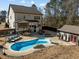 Aerial view of backyard showing pool, outdoor building and patio with fenced backyard at 3916 Bostwyck Dr, Fuquay Varina, NC 27526