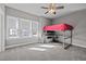 Bedroom features a loft bed with desk, plush carpet, large windows, and neutral paint at 3916 Bostwyck Dr, Fuquay Varina, NC 27526