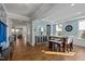 Open-concept dining area with hardwood floors and stylish modern furnishings at 3916 Bostwyck Dr, Fuquay Varina, NC 27526