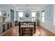 Bright dining area with modern light fixture, open to the kitchen and entryway at 3916 Bostwyck Dr, Fuquay Varina, NC 27526
