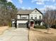 Inviting two-story home boasts a three-car garage and a charming red front door at 3916 Bostwyck Dr, Fuquay Varina, NC 27526