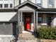 Inviting front entrance features a red door and stylish brick accents at 3916 Bostwyck Dr, Fuquay Varina, NC 27526