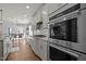 Open kitchen with stainless appliances and a view to the dining and Gathering rooms at 3916 Bostwyck Dr, Fuquay Varina, NC 27526
