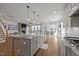 Open concept kitchen features a large island, stainless appliances, and hardwood floors at 3916 Bostwyck Dr, Fuquay Varina, NC 27526