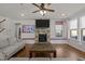 Inviting living room features a stone fireplace, hardwood floors, and cozy seating at 3916 Bostwyck Dr, Fuquay Varina, NC 27526