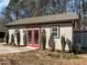 Exterior view of shed showcasing red doors and trimmed windows against the neutral siding at 3916 Bostwyck Dr, Fuquay Varina, NC 27526
