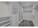 Walk-in closet with built in shelving, and plush carpet at 3916 Bostwyck Dr, Fuquay Varina, NC 27526