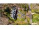 An aerial view of the home and its circular driveway surrounded by landscaping and trees at 400 Tharps Ln, Raleigh, NC 27614