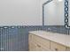 Charming half bathroom featuring blue patterned wallpaper, vanity, and decorative mirror at 400 Tharps Ln, Raleigh, NC 27614
