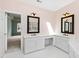 Bathroom with double vanity and mirrors, a window, and en-suite access at 400 Tharps Ln, Raleigh, NC 27614