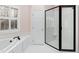 Bathroom featuring a glass shower and soaking tub next to a window at 400 Tharps Ln, Raleigh, NC 27614