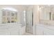Bathroom featuring soaking tub, glass enclosed shower, and natural light at 400 Tharps Ln, Raleigh, NC 27614